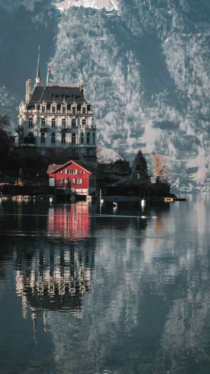 Swiss lakeside architecture reflected in still water