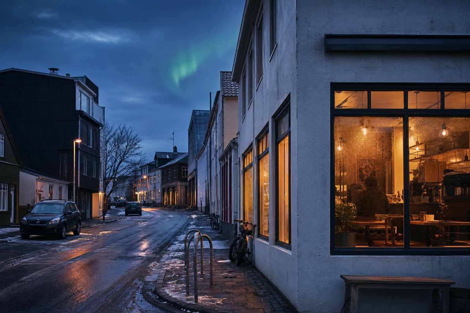 Warm cafe windows glow beneath a dark Reykjavik winter sky.